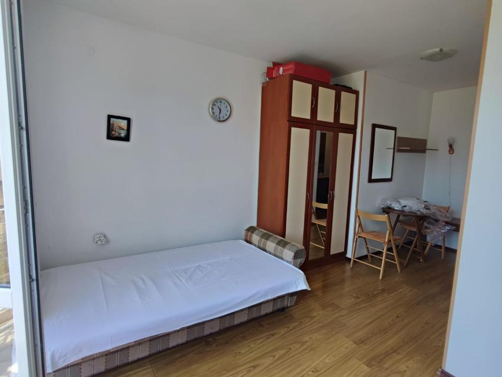 a small bedroom with a bed and a table at Комплекс Виста Дел Мар 2, студио in Sunny Beach