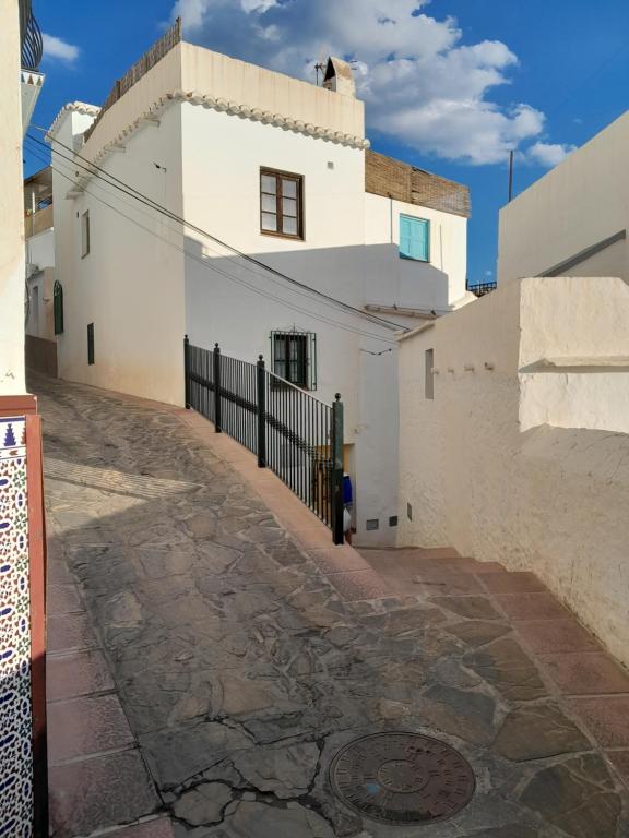 an alley in front of a white building at Casa Jasmin, Competa in Cómpeta