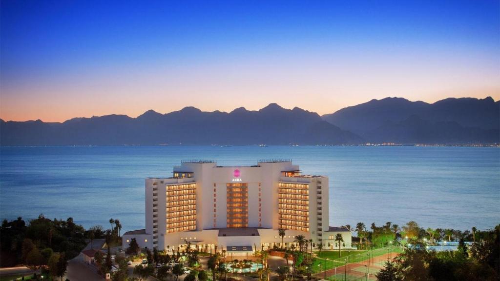 a hotel with a view of the ocean and mountains at Akra Hotel in Antalya