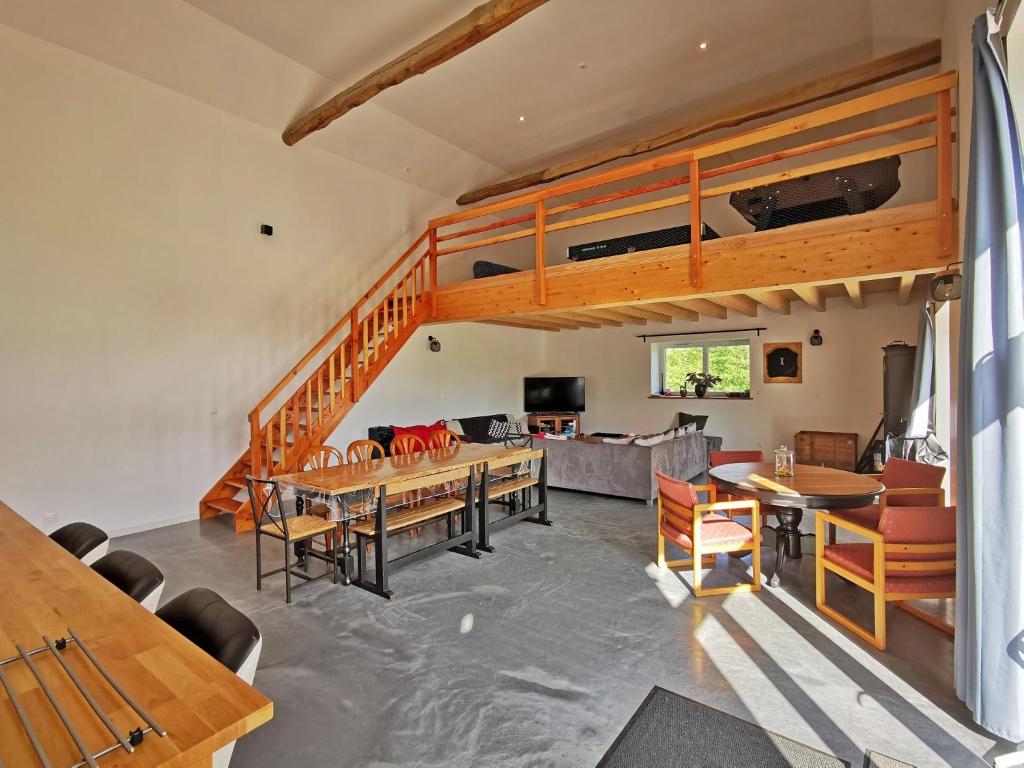 a living room with a loft bed and a couch at A l&#39;Orée du Lac, 500m lac de Chamboux in Saint-Martin-de-la-Mer