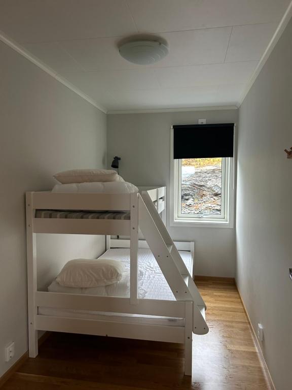 a white bunk bed in a room with a window at Tärnaby UpHill in Tärnaby