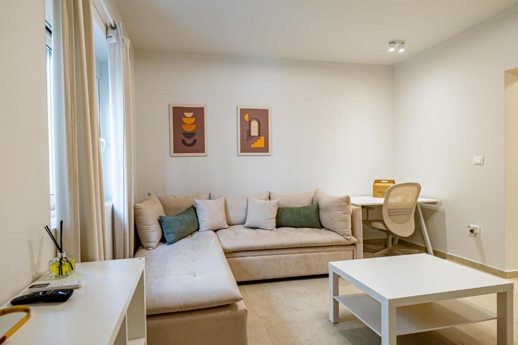 a living room with a couch and a table at Renovated 1st-floor apt-close to the park in Athens
