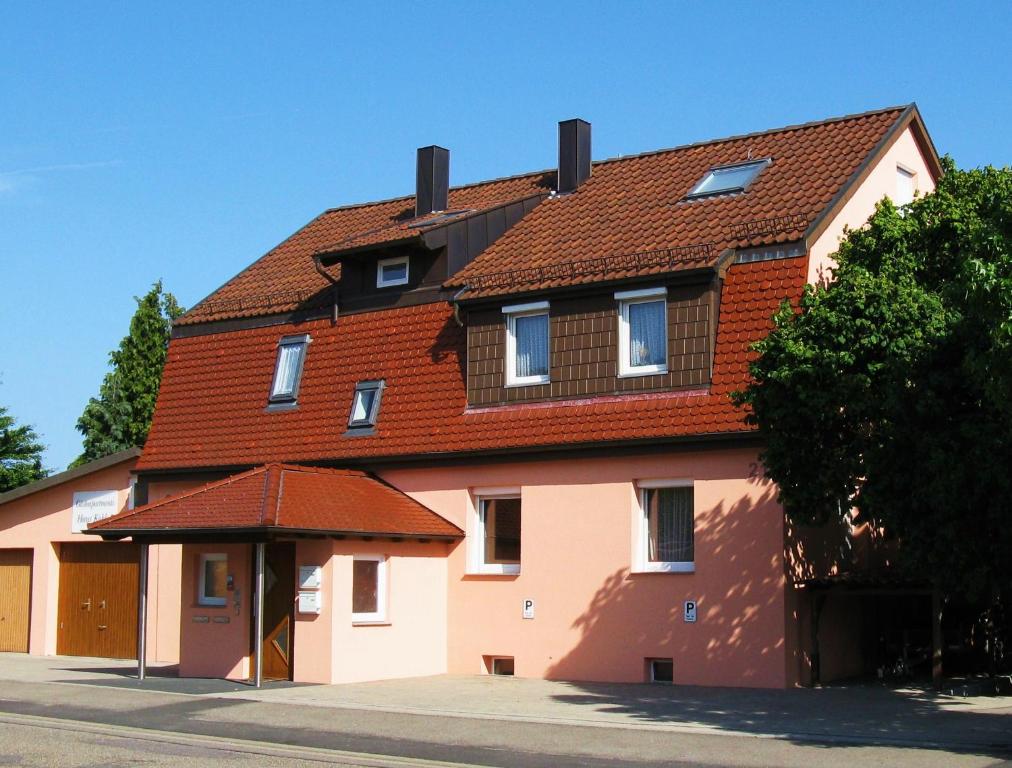 uma casa grande com telhado vermelho em Gästeapartments Haus Kohler em Abstatt