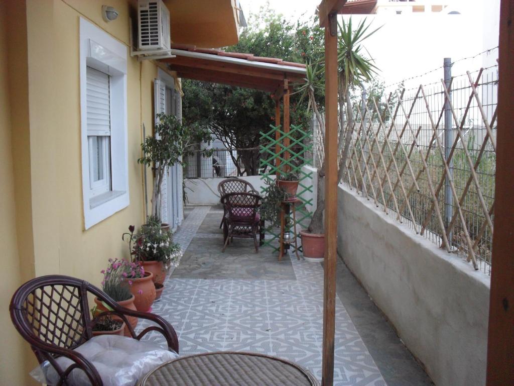a patio with chairs and tables on a balcony at La Santre Villa in Amoudara Herakliou