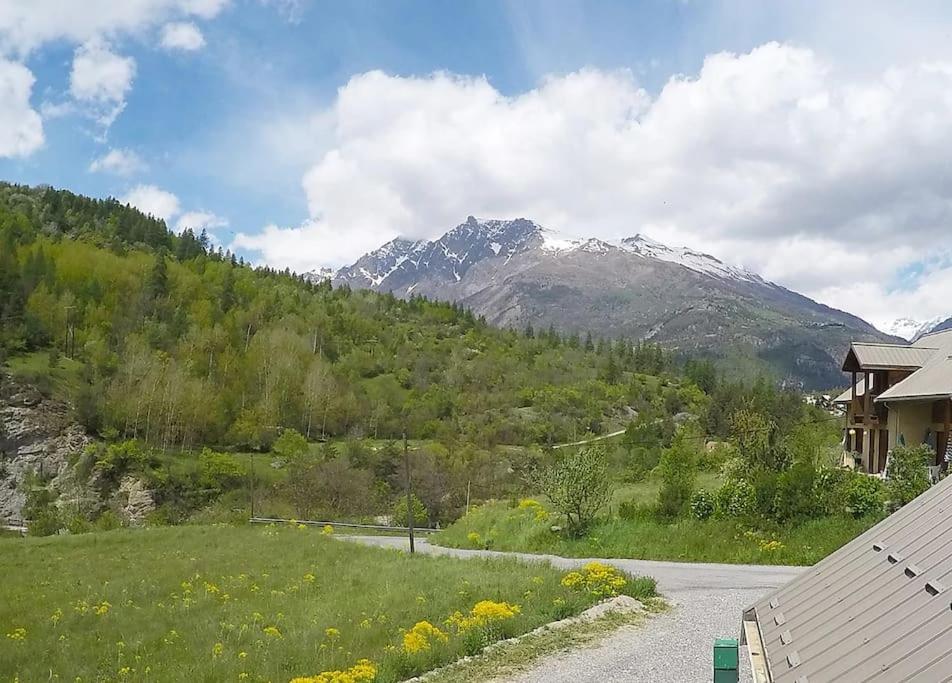 a view of a mountain with a house and a road at APPARTEMENT DANS CHALET 6 PERSONNES in Vallouise
