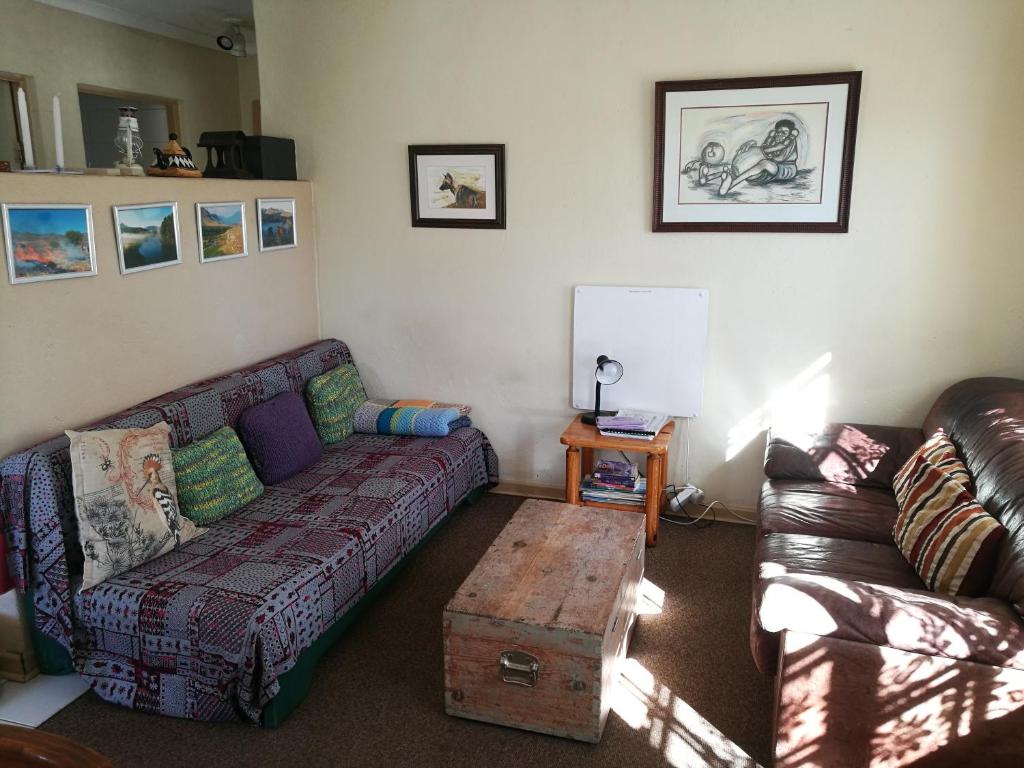 a living room with a couch and a coffee table at Snow Cottage in Rhodes