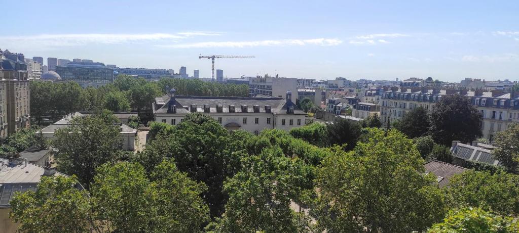 a view of a city with trees and buildings at Logement entier, vue, Paris centre, Catacombes in Paris