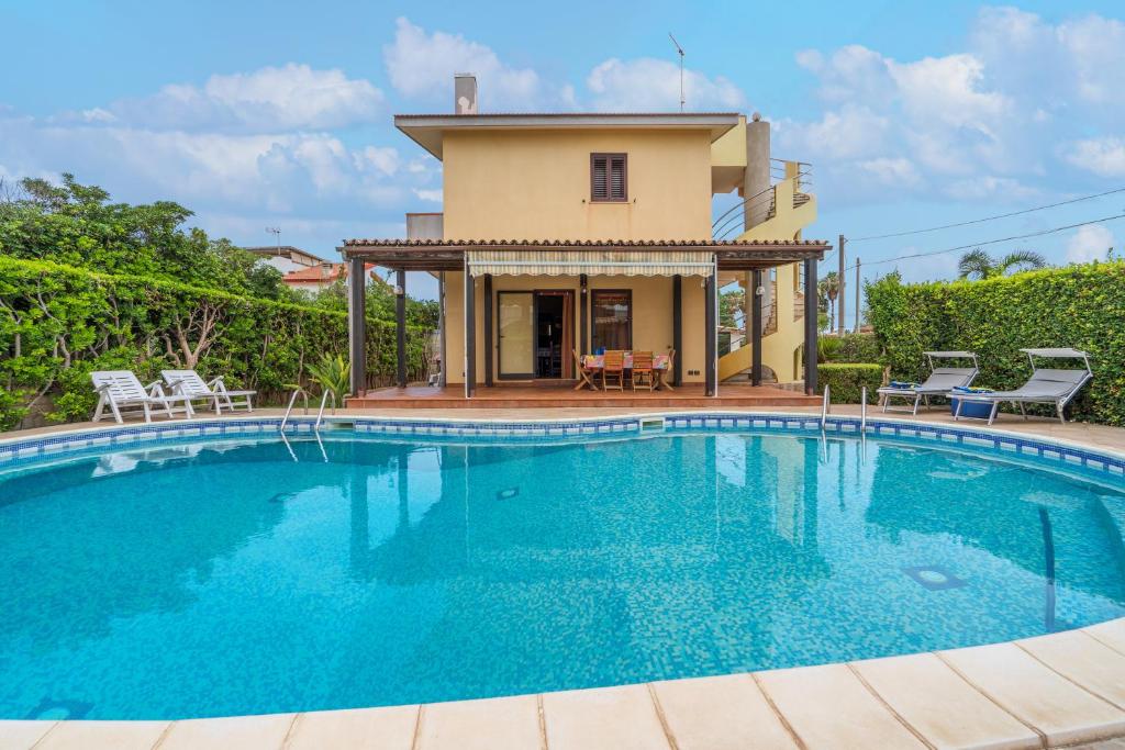 a large swimming pool in front of a house at Villa Raffa in Avola