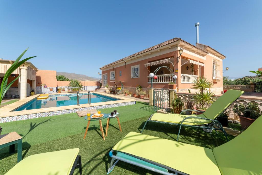 a villa with a swimming pool and a house at Villa Mansa in Pechina