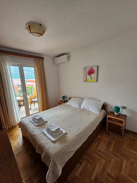 Postel nebo postele na pokoji v ubytování Apartments & Rooms Vuksanovic Ivana