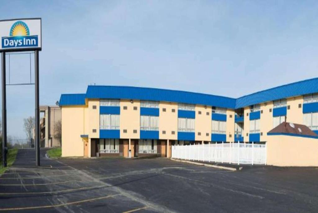 an empty parking lot in front of a building at Days Inn by Wyndham Fort Wright Cincinnati Area in Fort Wright
