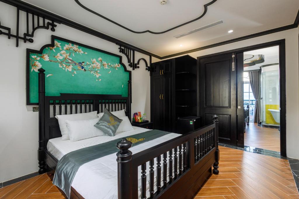 1 dormitorio con 1 cama grande y pared verde en De Stefano Coffee and Hotel en Phu Quoc