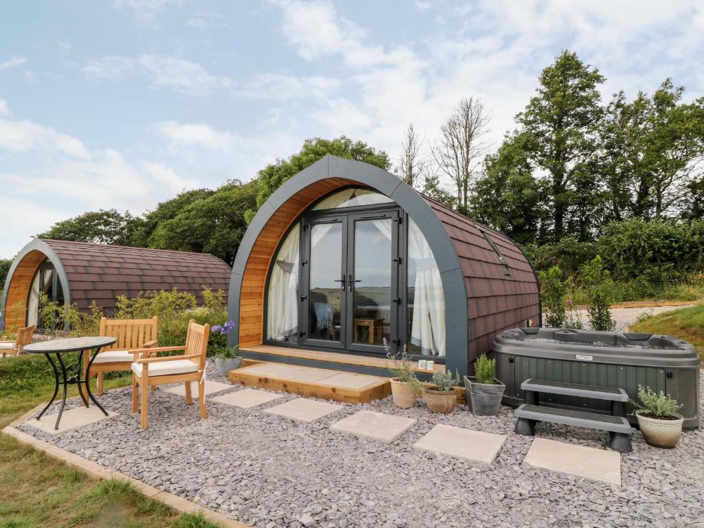 a small dome house with a grill and a table at Ash in Saltash