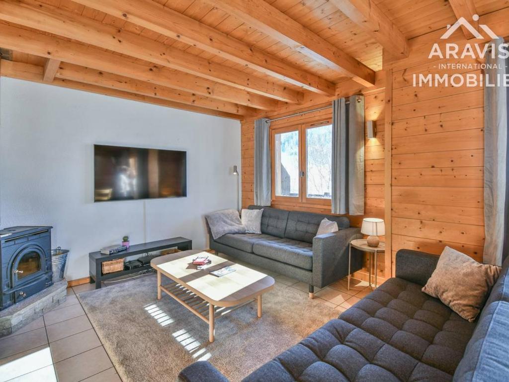 a living room with a couch and a fireplace at Chalet Le Grand-Bornand, 5 pièces, 8 personnes - FR-1-391-158 in Le Grand-Bornand