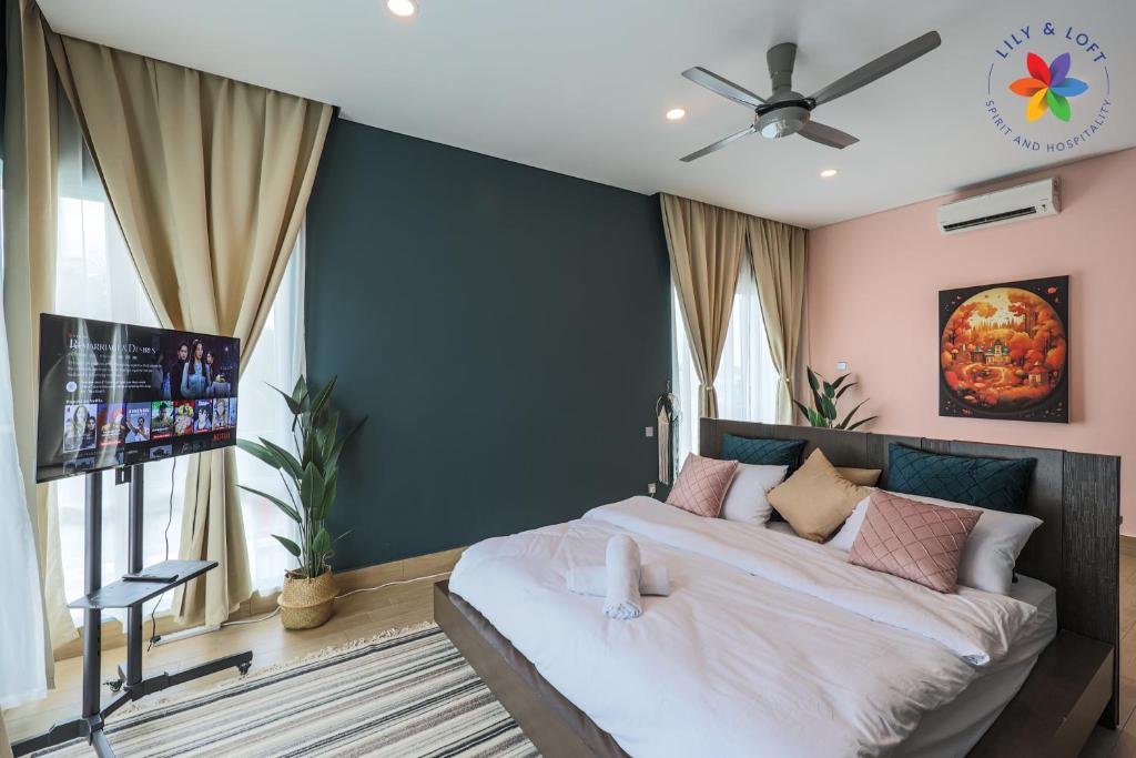 a bedroom with a large bed and a flat screen tv at Private Studio in Bungalow by LilyandLoft in Subang Jaya