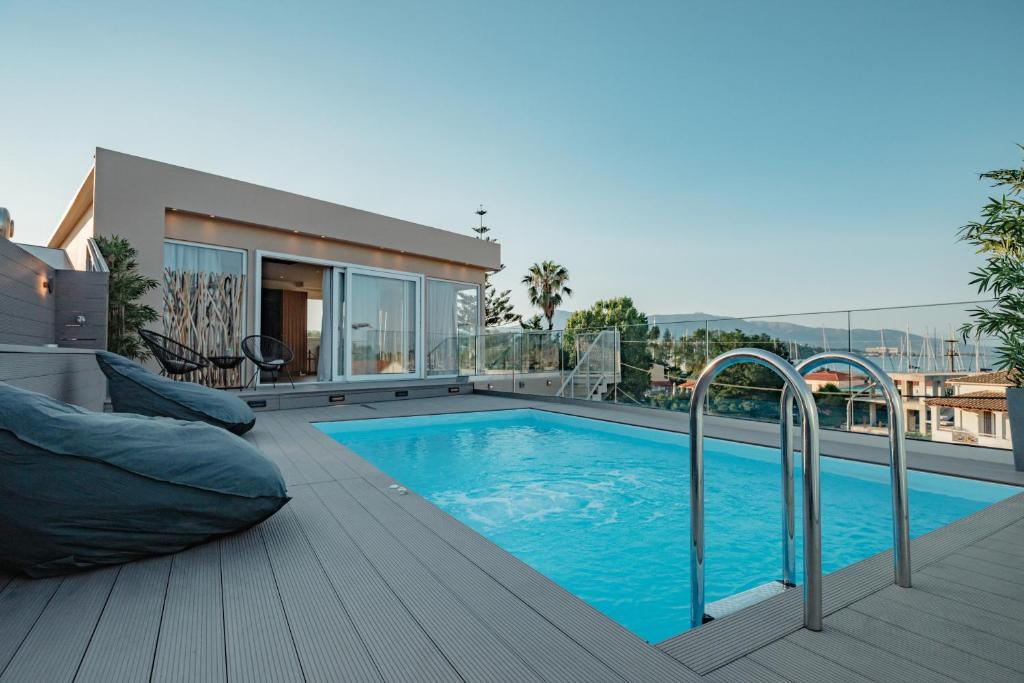 a swimming pool on the deck of a house at Daedalus Luxury Home - Seaview & Heated Pool in Kontokali