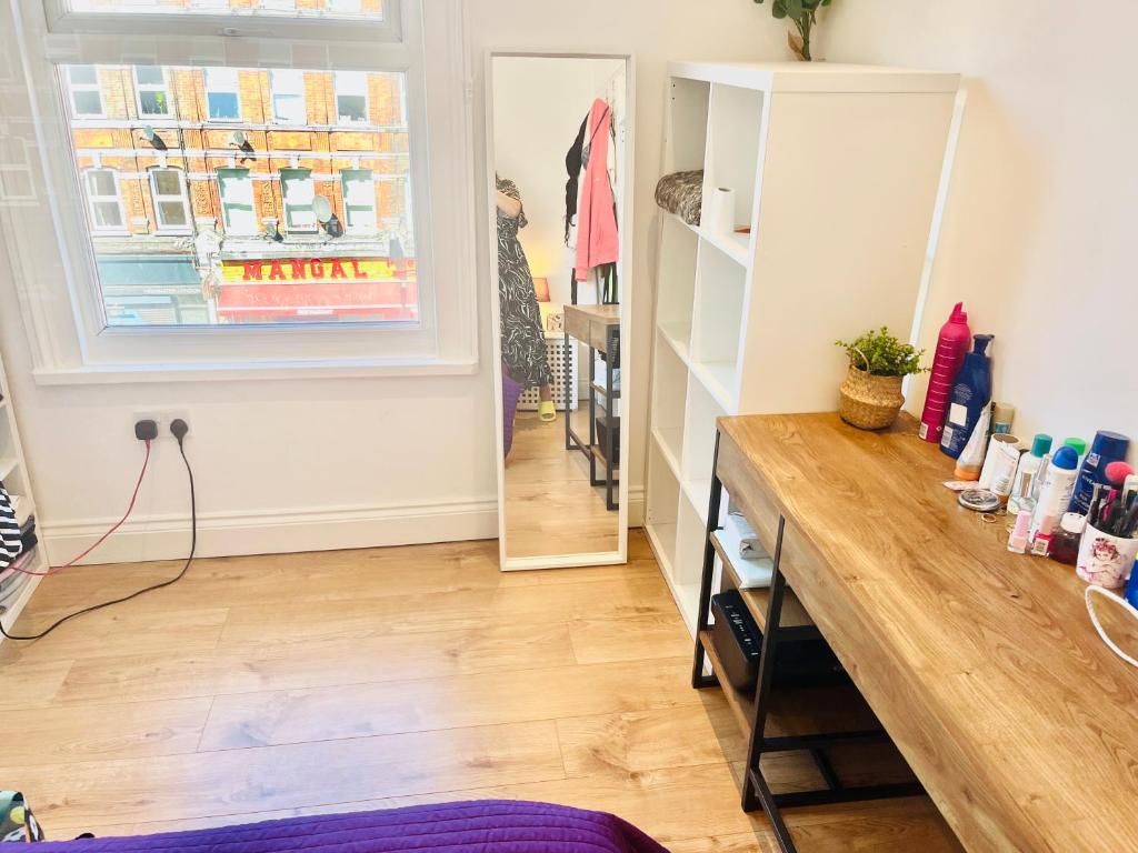 a dressing room with a table and a mirror at Very Lovely and Central 1-Bed Apartment in London in London