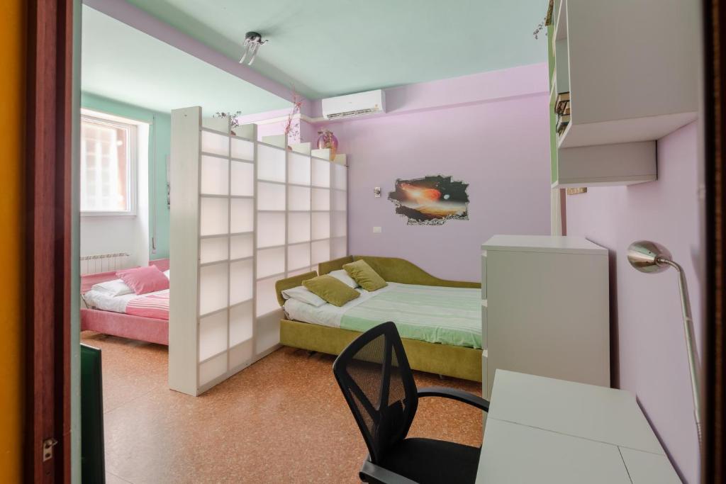 een kamer met een bed en een bureau met een stoel bij House of colours in Marconi, Roma in Rome