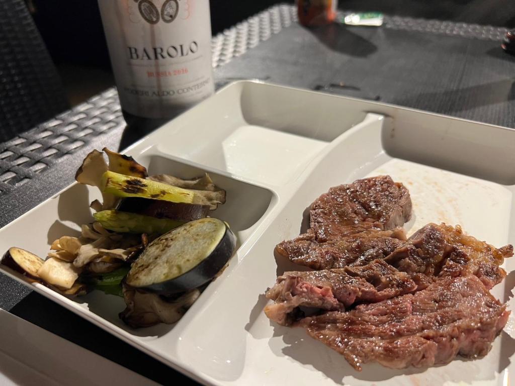 a plate of food with meat and vegetables on a table at KAI Ichinomiya in Ichinomiya