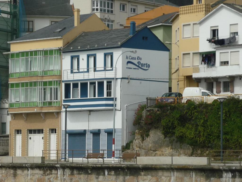ein weißes und blaues Gebäude neben einigen Gebäuden in der Unterkunft A Casa do Porto in Burela