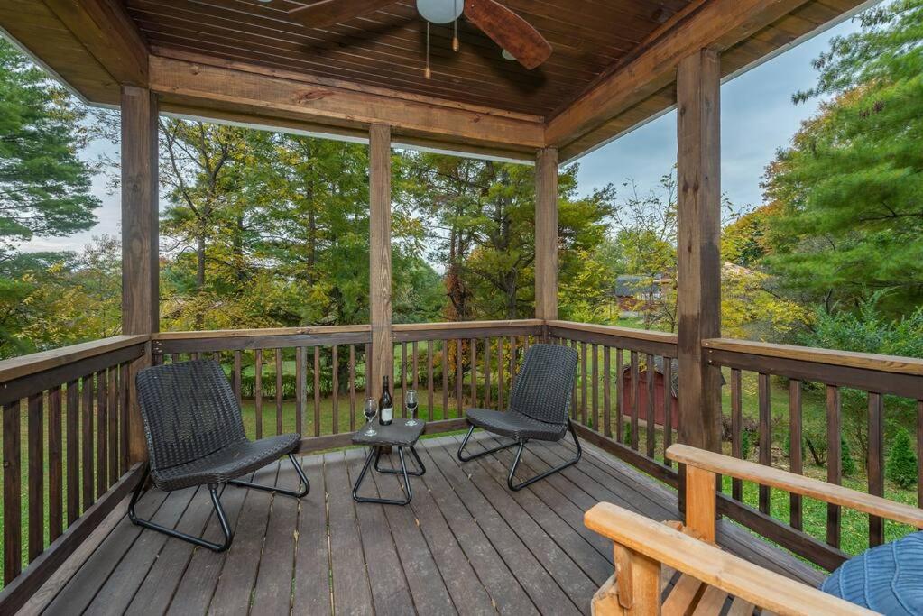 a screened in porch with two chairs and a bench at Panorama Place! Comfy Asheville Retreat Sleeps 10! in Asheville