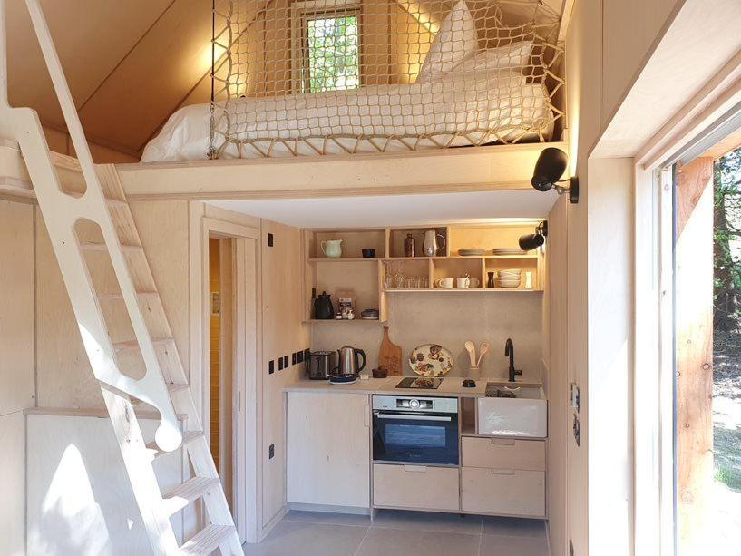 a tiny kitchen with a staircase in a tiny house at Mertrick in Forest Mill
