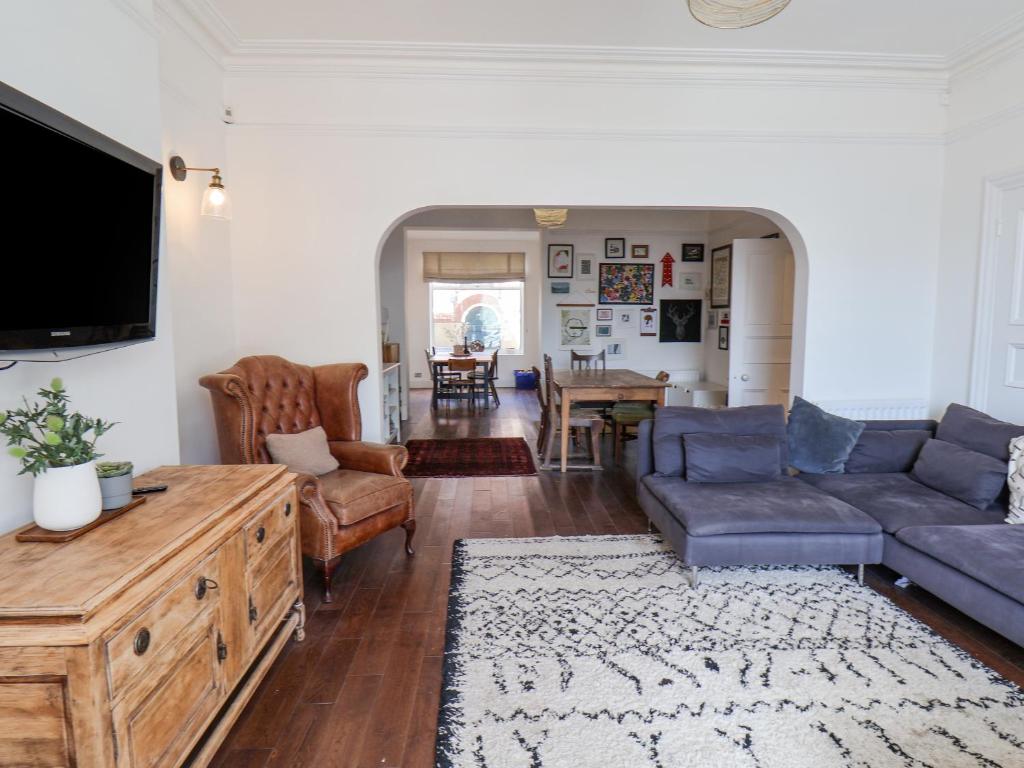 a living room with a couch and a tv at 12 Westfield Terrace in Saltburn-by-the-Sea