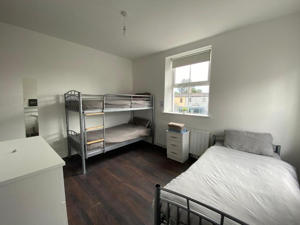 a bedroom with a bunk bed and a window at Sarsfield Hostel in Dublin
