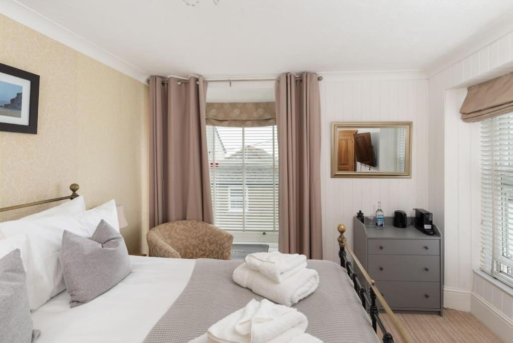 a bedroom with a bed with towels on it at Room 3 Hotel style Double bedroom in Marazion in Marazion