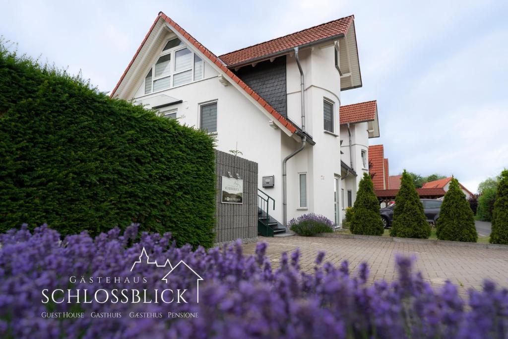 a house with purple flowers in front of it at Gästehaus Schlossblick in Wernigerode
