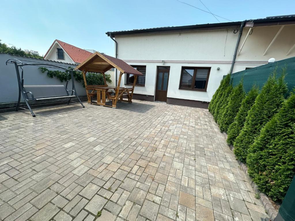 a patio with a picnic table and a house at Luna's house in Sibiu