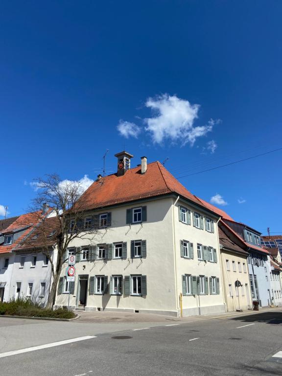 a large white building with a red roof at Hostel Balingen in Balingen
