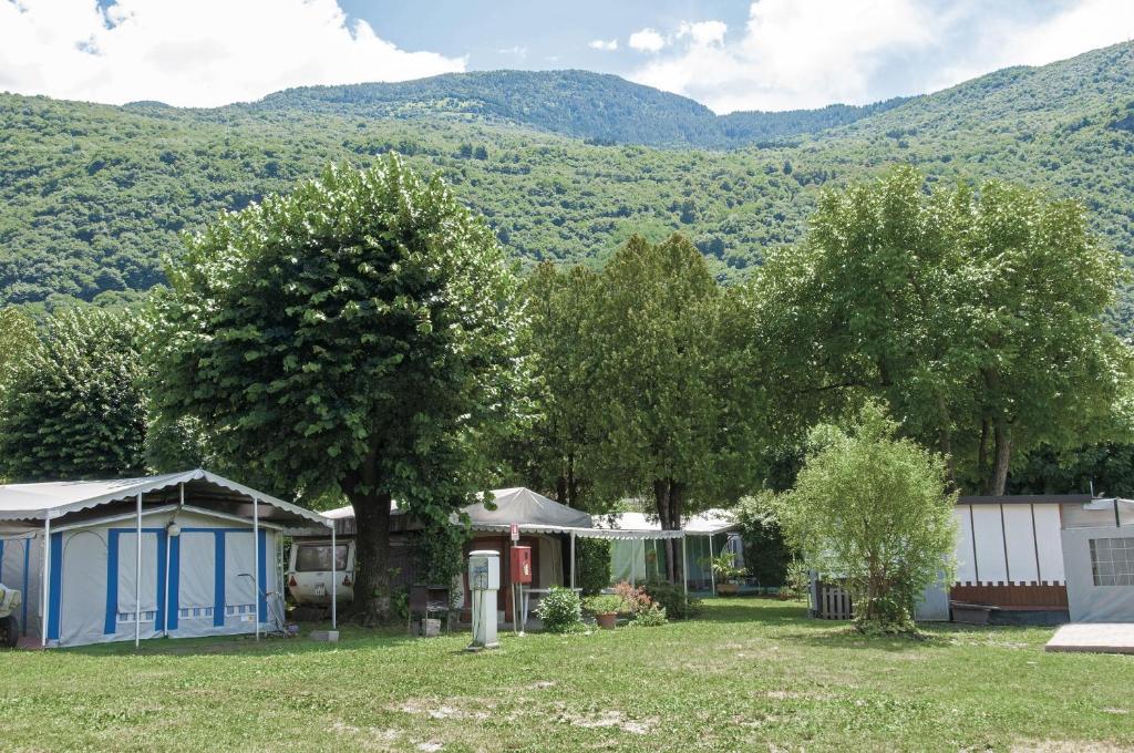 a group of houses with mountains in the background at Green Village Accommodations in Colico