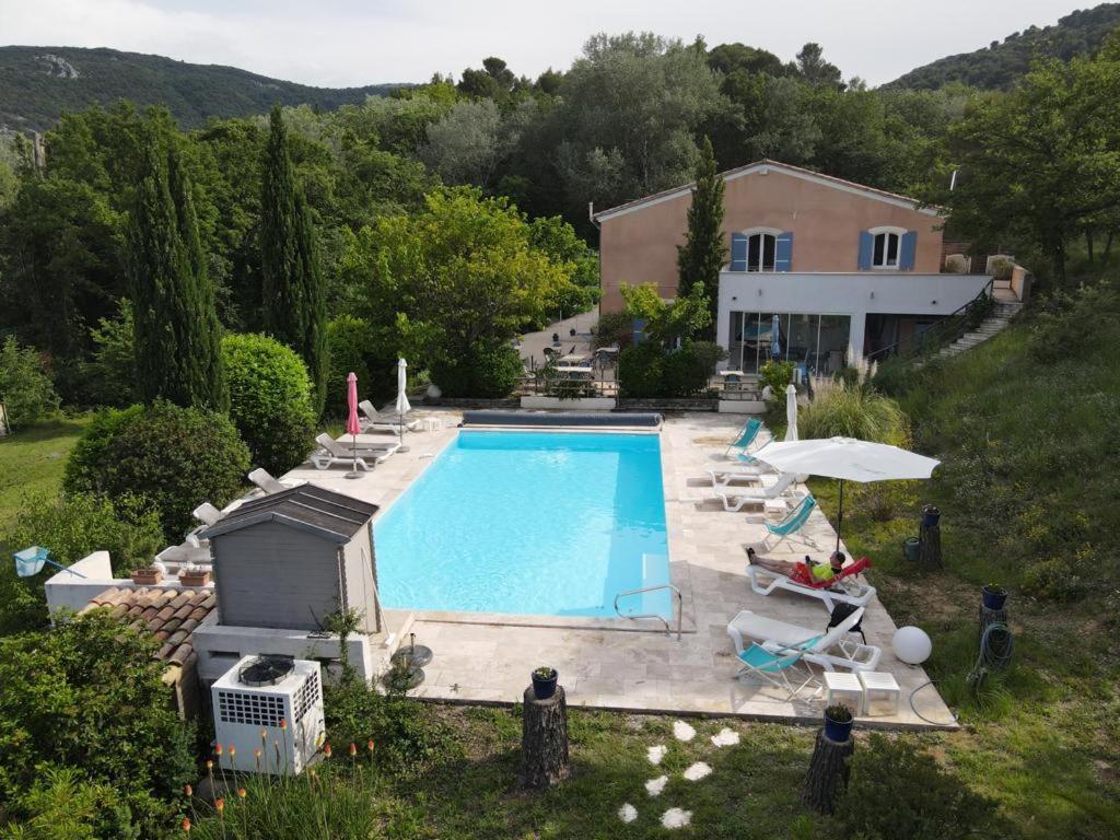 an aerial view of a house with a swimming pool at HOTEL LE MAS D'HèLèNE in Crestet