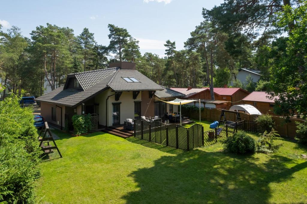 an aerial view of a house with a yard at Pine House by Sea in Pobierowo