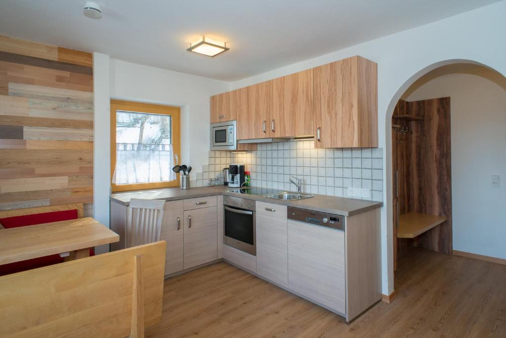 a kitchen with wooden cabinets and a counter top at Apartment Alpenperle in Schladming