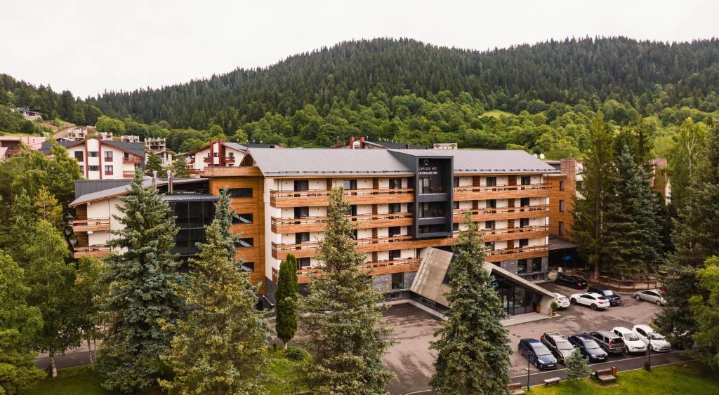 an aerial view of a hotel with a parking lot at Bakuriani Inn in Bakuriani