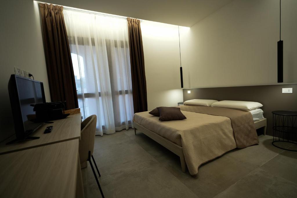 una camera d'albergo con letto e TV di Domus Smeralda B&B a Porto Cervo