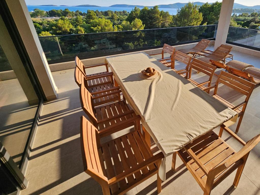 a table and chairs on a balcony with a view at AHIL Sport&health premium penthouse Šibenik in Šibenik