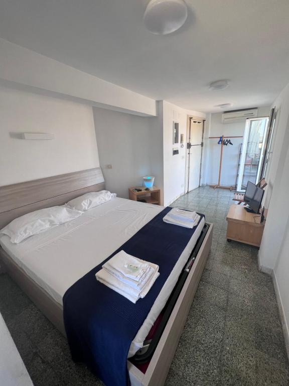 a bedroom with a large bed with a blue blanket at Appartamento con ampio Terrazzo in Rome