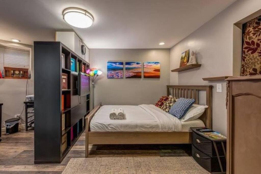 a bedroom with a bed and a book shelf at Lovely apartment near U-Chicago in Chicago