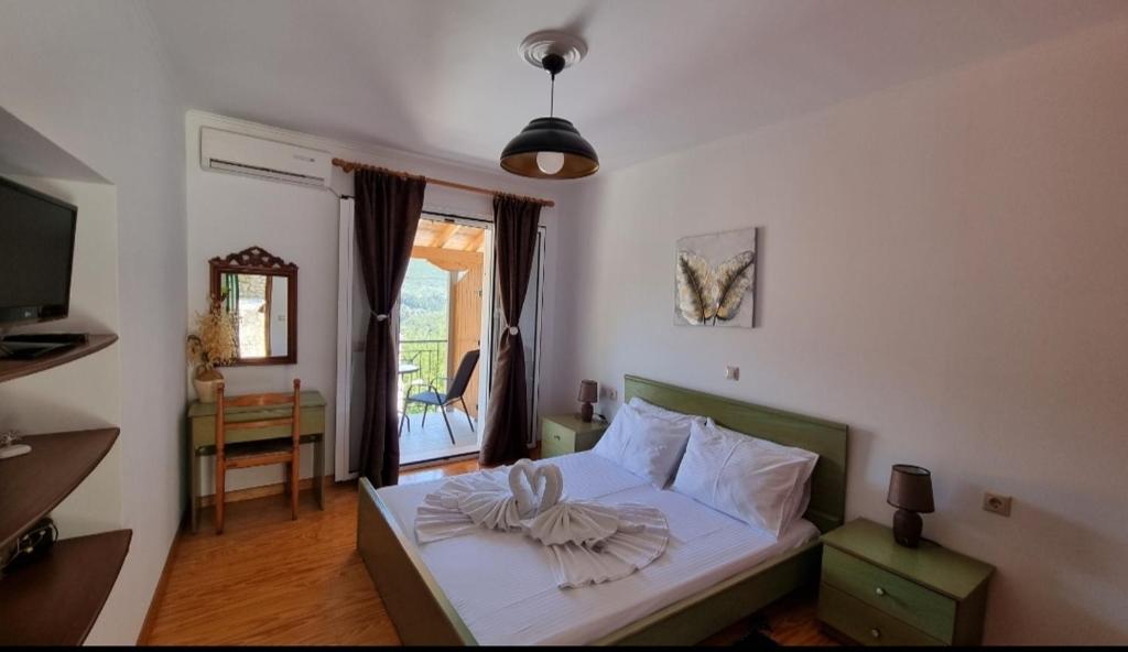Un dormitorio con una cama con una toalla. en Sandra Apartment en Katokhórion