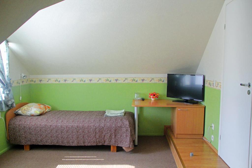 TV a/nebo společenská místnost v ubytování Rivaal Guesthouse-Cafe