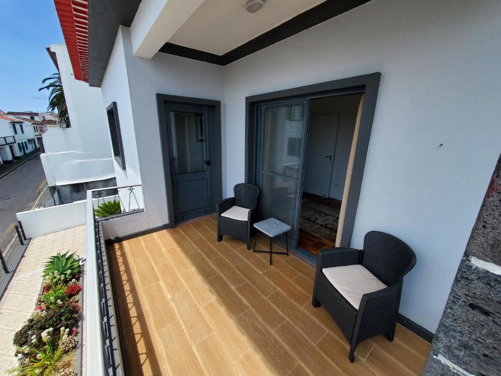 a balcony with two chairs and a table at Pousada da Vila in Vila Franca do Campo