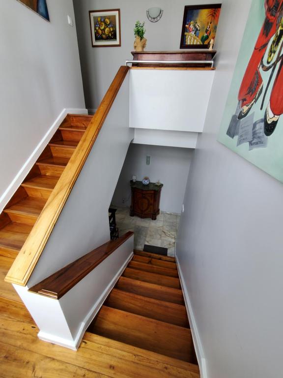 a staircase in a home with wooden floors and white walls at Pousada da Vila in Vila Franca do Campo