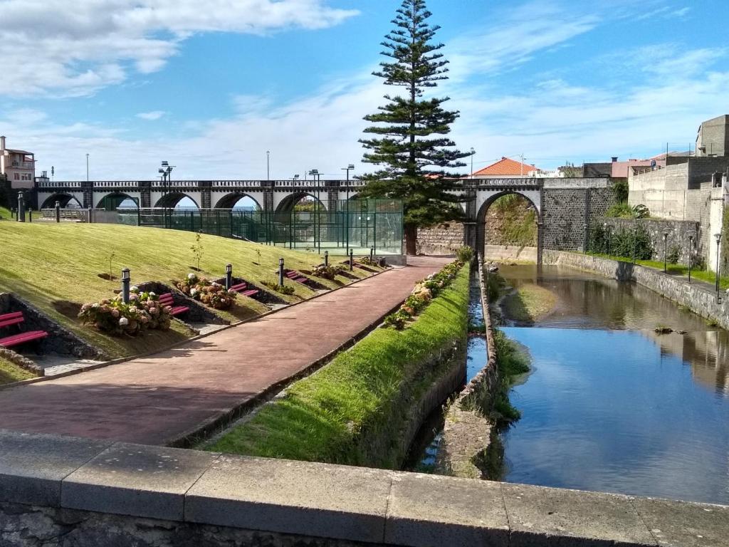 a bridge over a river in a city at Pousada da Vila in Vila Franca do Campo