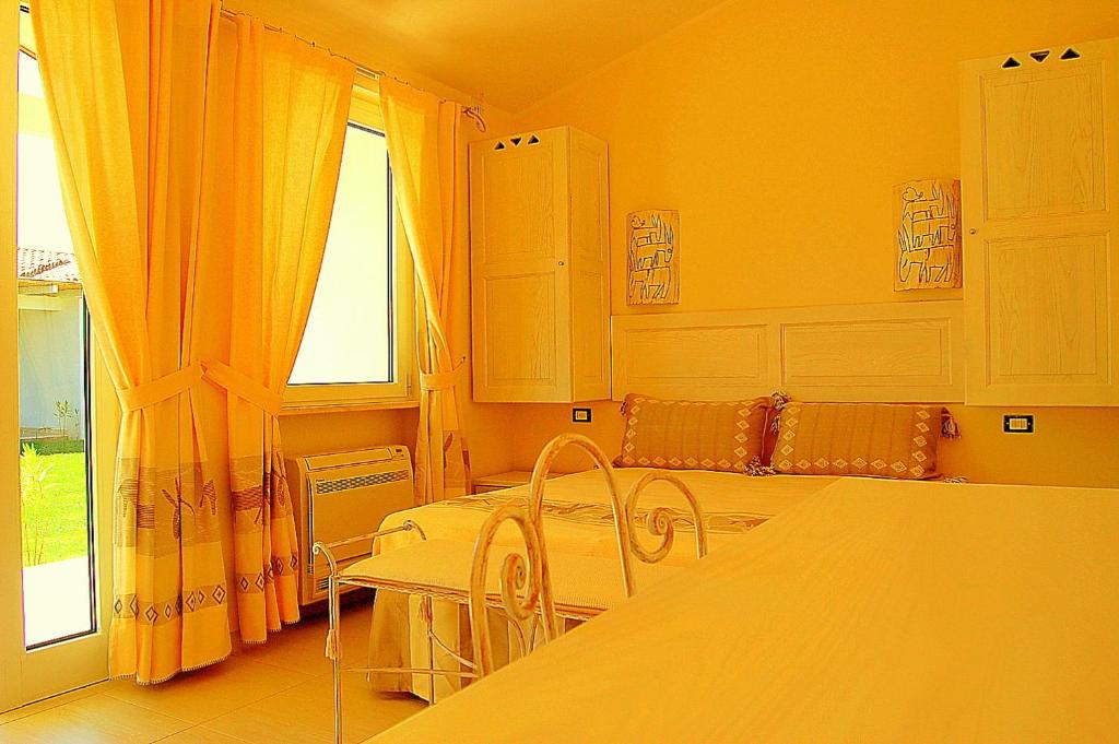 Postel nebo postele na pokoji v ubytování Hotel Budoni Beach