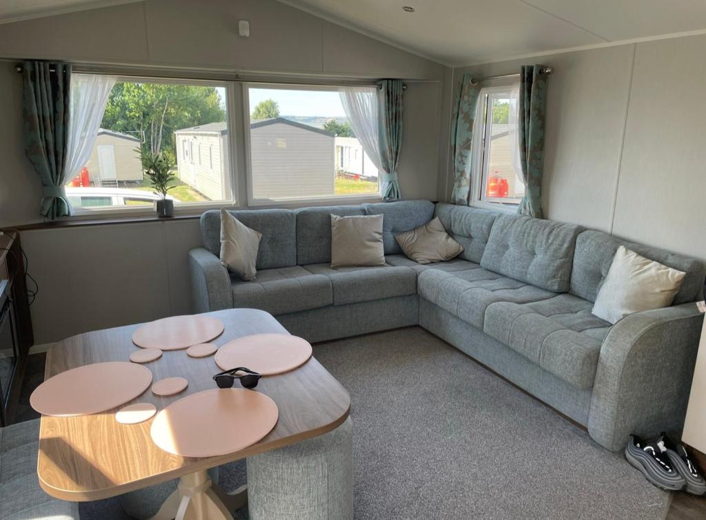 a living room with a couch and two tables at 29 sea reach in Allhallows