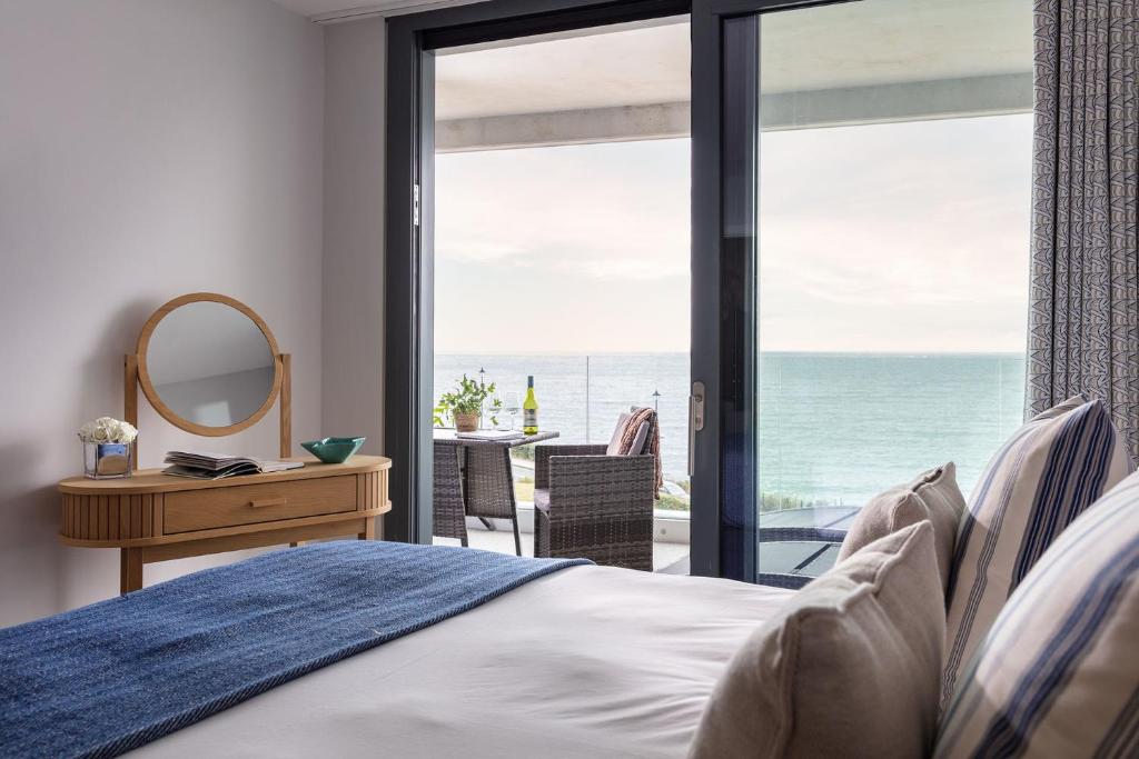 a bedroom with a bed and a view of the ocean at St Michaels The Liner in Falmouth