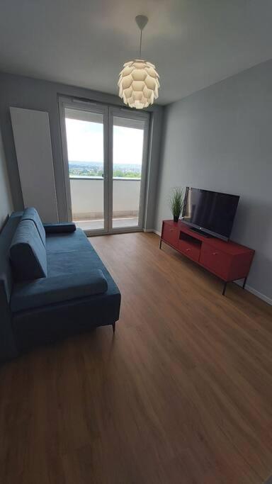 a living room with a couch and a television at Apartament PRIME Self check-in in Rzeszów